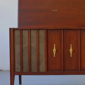 Vintage wooden cabinet with woven panels and gold handles.