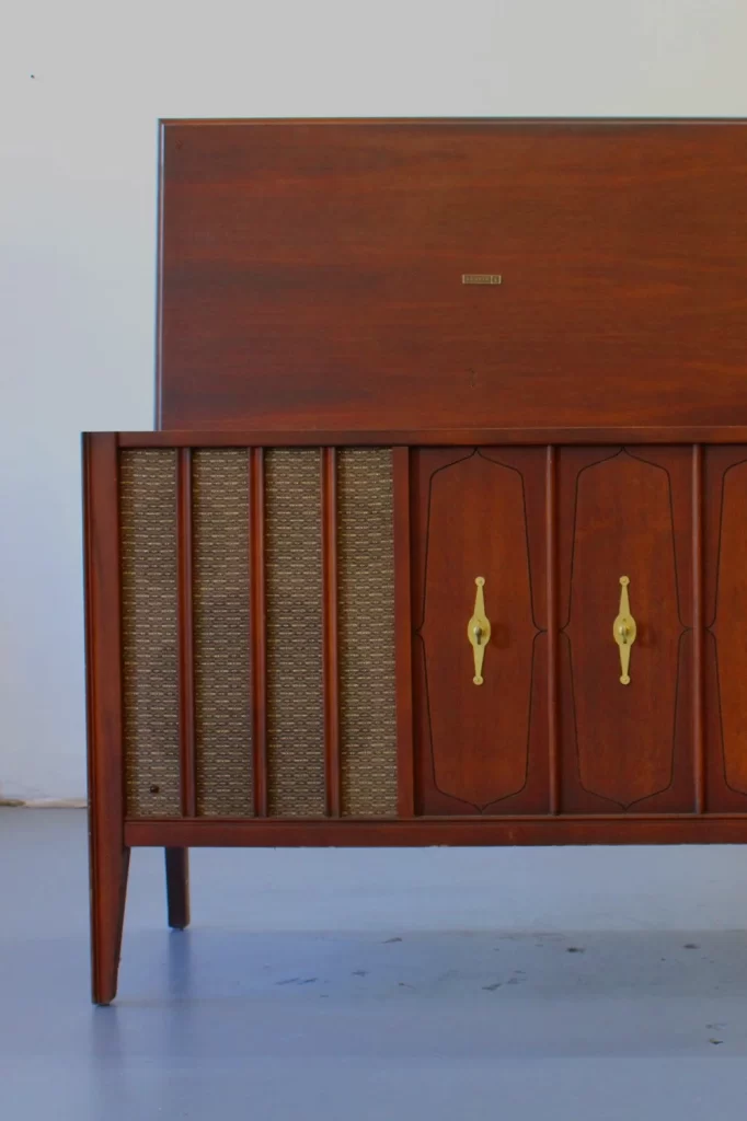 Vintage wooden cabinet with woven panels and gold handles.