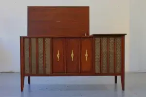 Restored Zenith mid-century modern stereo console with original walnut finish, brass hourglass pulls, and integrated high-res streaming.