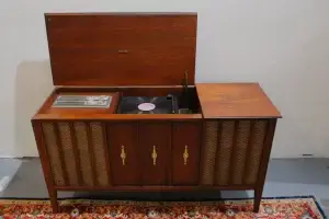 Restored Zenith mid-century stereo console showing the internal turntable, radio tuner, and original walnut finish.