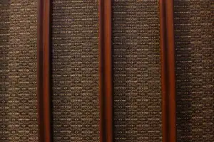Close-up of the original textured mid-century speaker grille cloth on a restored Zenith walnut stereo console.