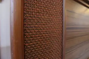 Close-up of the pristine vintage speaker cloth and original wood trim on the RCA Victor "Cassidy" console.