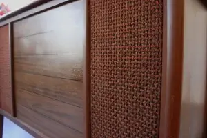 Eye-level view of the refinished walnut wood grain and vintage speaker cloth on the RCA Victor "Cassidy" console.