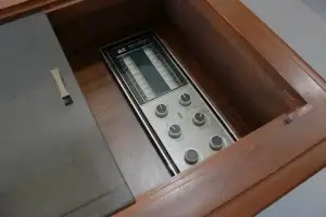Top-down view of the custom smoked glass top sliding open to reveal the restored RCA Victor controls on the Cassidy console.