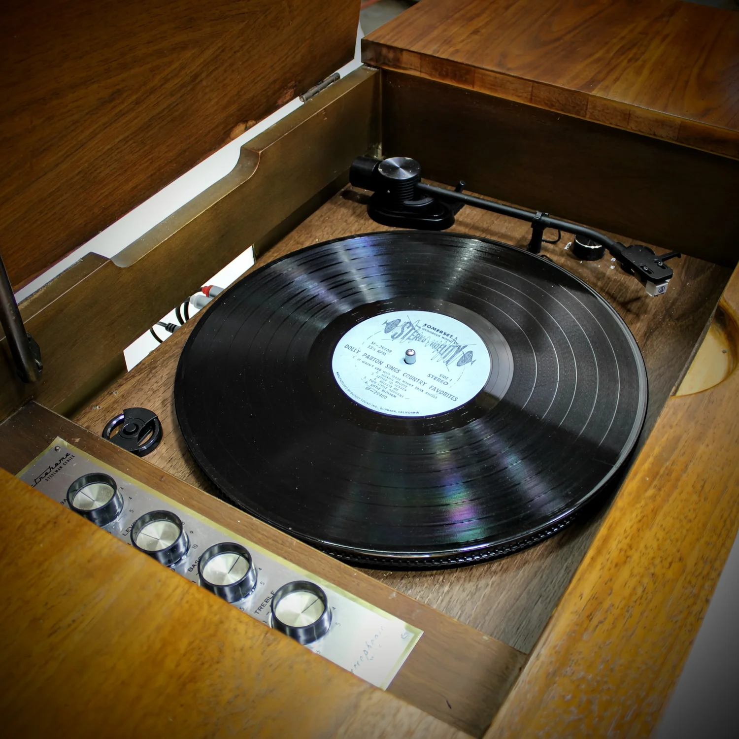 Vintage record player with Dolly Parton album playing.