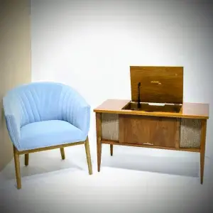 Vintage wooden record player and blue chair.
