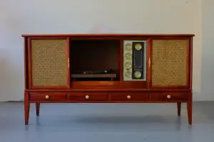 A refinished Philco mid-century modern stereo console with sliding front doors open to reveal a modern turntable and a detailed vintage radio tuner.