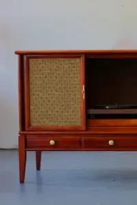 Eye-level front view of a refinished Philco mid-century stereo console with sliding doors open to reveal a modern turntable and gold radio tuner.