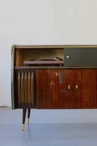 Vintage wooden cabinet with record player inside.