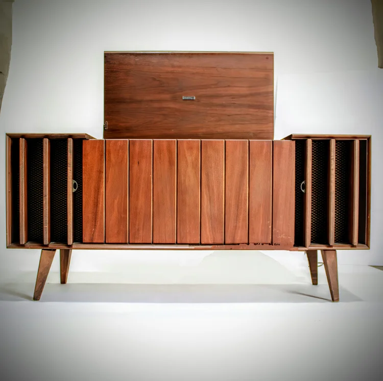 Mid-century modern wooden cabinet with doors and speakers.
