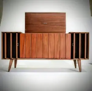 Wooden sideboard with doors and speakers, mid-century modern design.