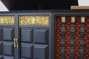 Close-up of the front gold trim and vintage red and black speaker cloth on a custom GE Multiplex console.