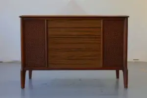 Front view of a restored RCA Victor "Cassidy" stereo console featuring a custom smoked glass sliding top and natural wood finish.