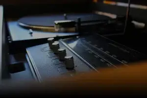 Close-up of a vintage record player with knobs and dials.