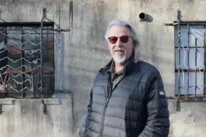 Jack Steiner wearing sunglasses standing in front of a concrete wall.