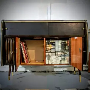 Mid-century modern bar cabinet with open doors, revealing storage for records and glasses.