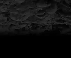 Dark gray rocky cliffside with rough texture and shadows.