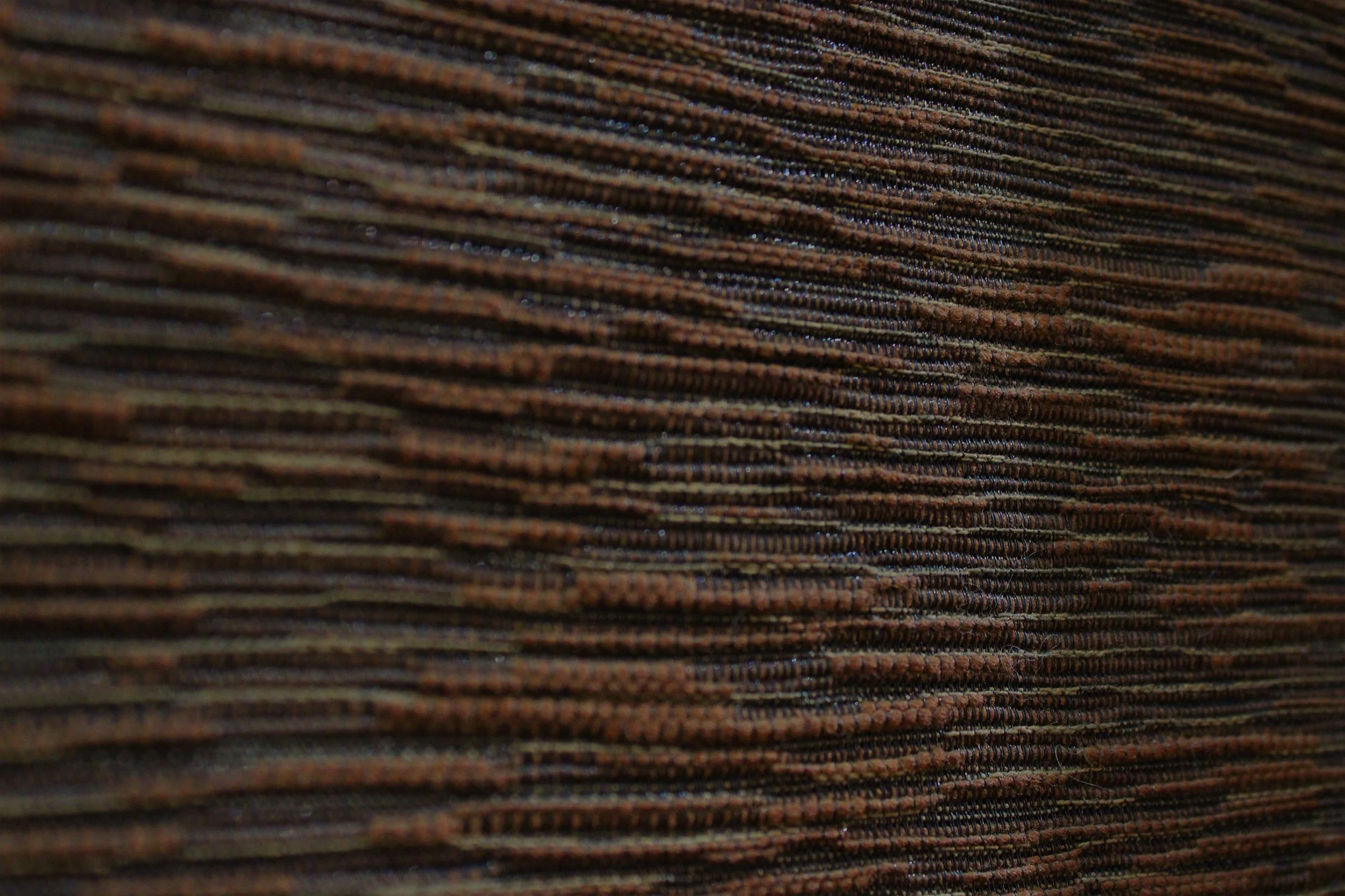Close-up of brown fabric with horizontal texture.