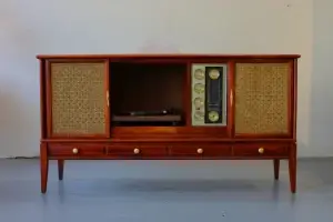 Vintage wooden cabinet with record player and radio.