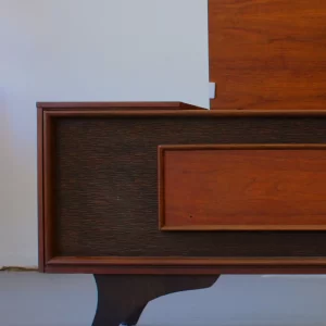 Mid-century modern wooden side table or nightstand with a drawer.