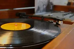 Close-up of a high-fidelity needle and vinyl record on a new Audio-Technica turntable inside a restored GE Kubrick.