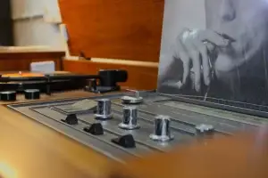 Close-up of the illuminated tuning dial and radio interface on a restored GE Kubrick console.