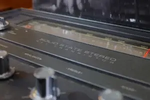 Close-up of the Bass, Treble, and Balance knobs on a restored General Electric Kubrick console.