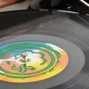 Close-up of a vinyl record playing on the new Audio-Technica turntable inside a restored Brubeck console.
