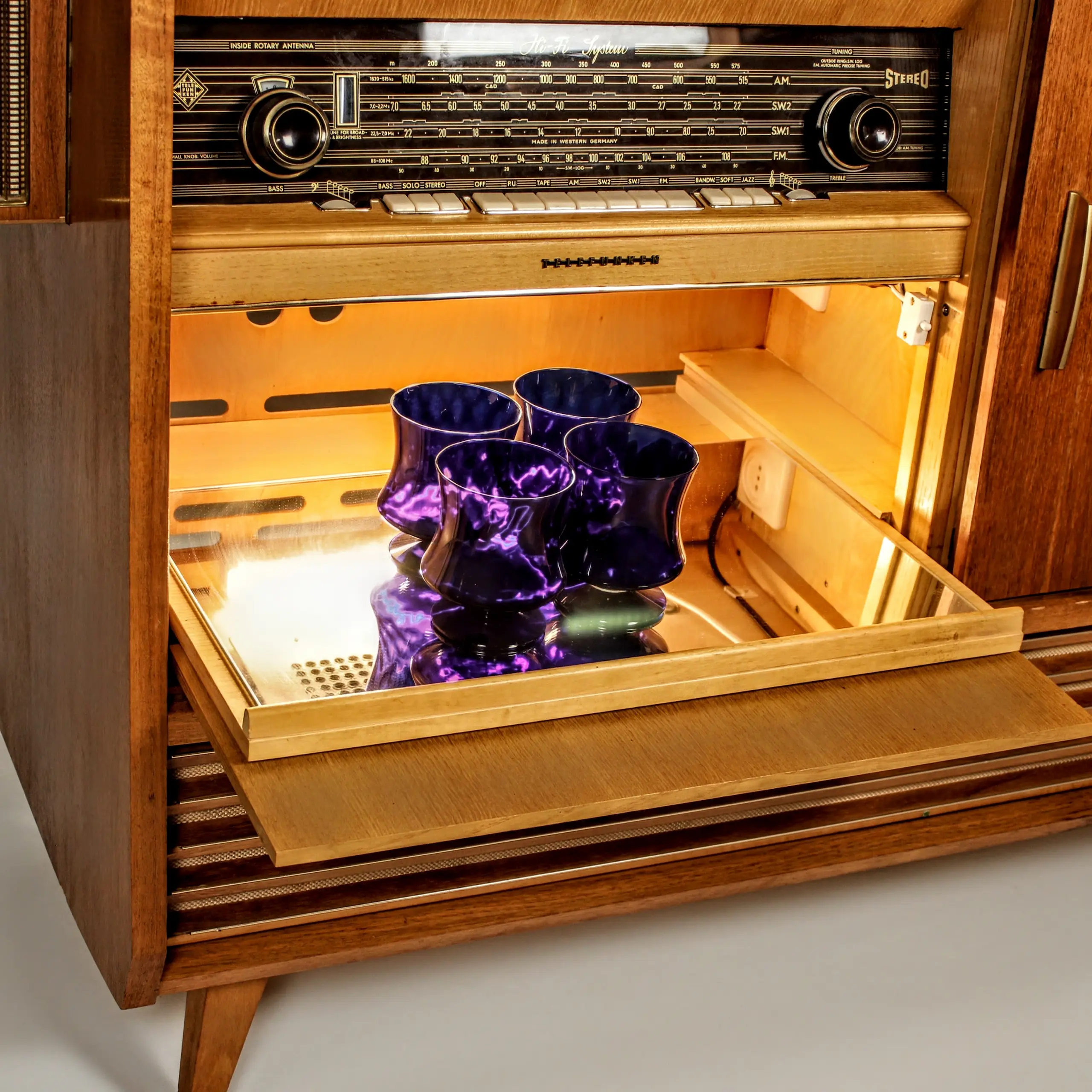 Front view of "The Judge" with sliding doors open to reveal the lit turntable and bar area.