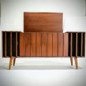 A mid-century Zenith stereo console with its top lid lifted open and slatted walnut doors slid back to reveal the internal turntable compartment and speakers.